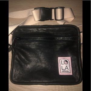 LOLA California black Hippie “Mondo” Fannie pack with ivory strap.
